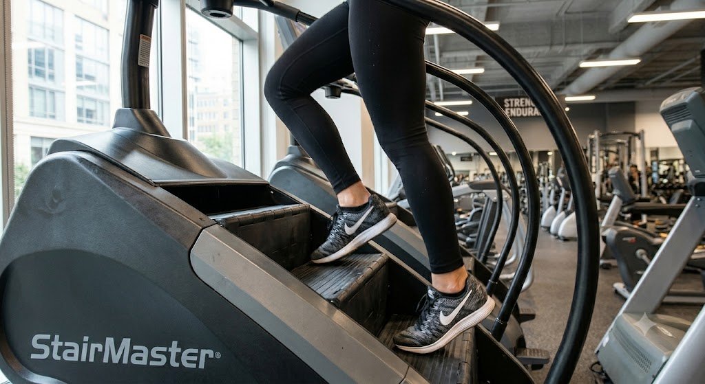 Person Using StairMaster Stepmill — stairmaster or treadmill