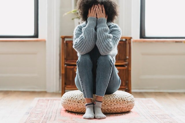 Depressed woman sitting on the floor